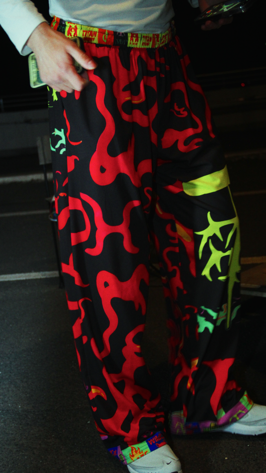 Wide-leg pants with bold graphic print, elastic waistband, and pockets – Tamaro Tigro TurboFyre Pants