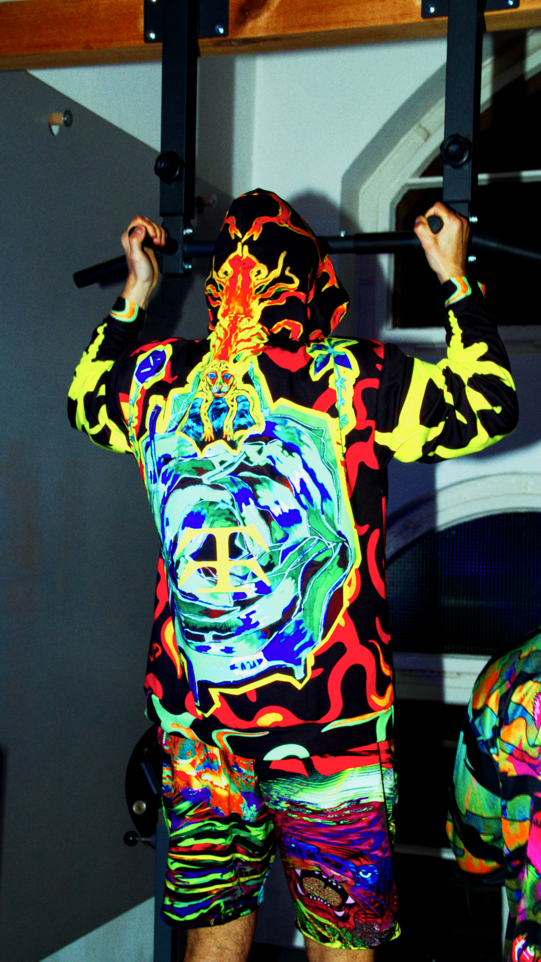 All-over print unisex hoodie with double-lined hood and fleece lining – Tamaro Tigro TurboFyre Hoodie
back view and Quick-dry swim shorts with bold print, mesh lining, and UPF 50+ – Tamaro Tigro TideBoy Shorts